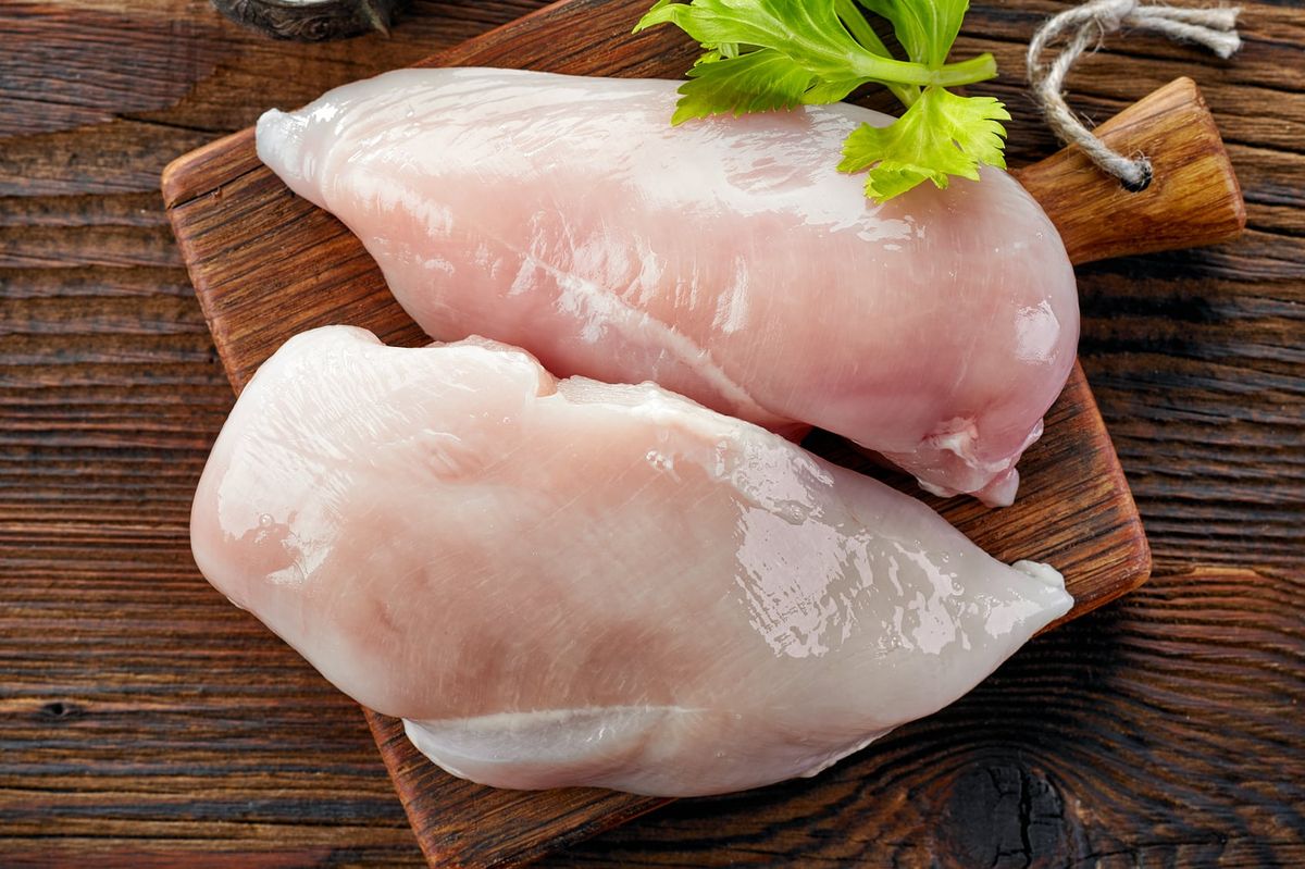 Raw chicken breast on cutting board